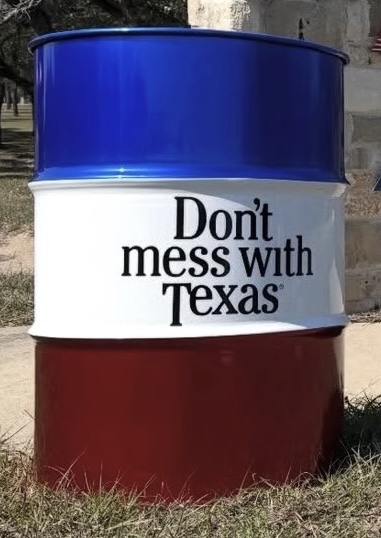 Red, white, and blue 55-gallon barrel with 'Don't Mess With Texas' printed on it