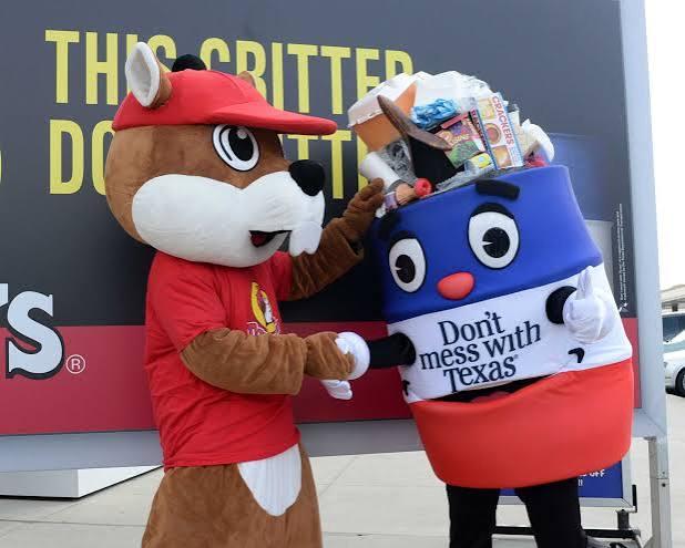 Texas Works Services barrel mascot greeting another mascot at a community event